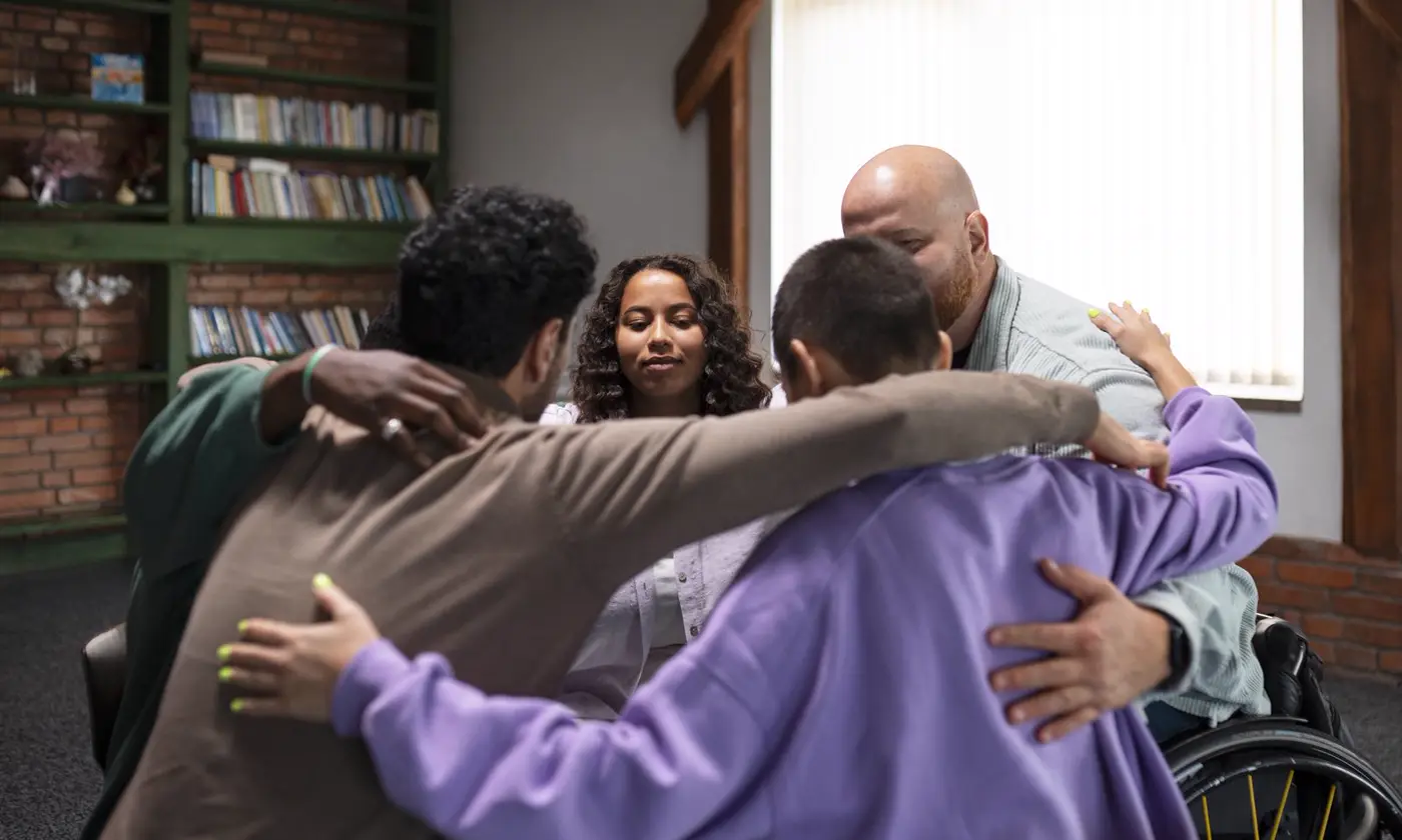 People sitting together in a supportive group session